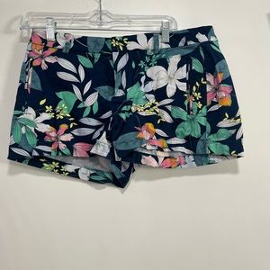 Navy shorts with white, green, and pink hibiscus flowers